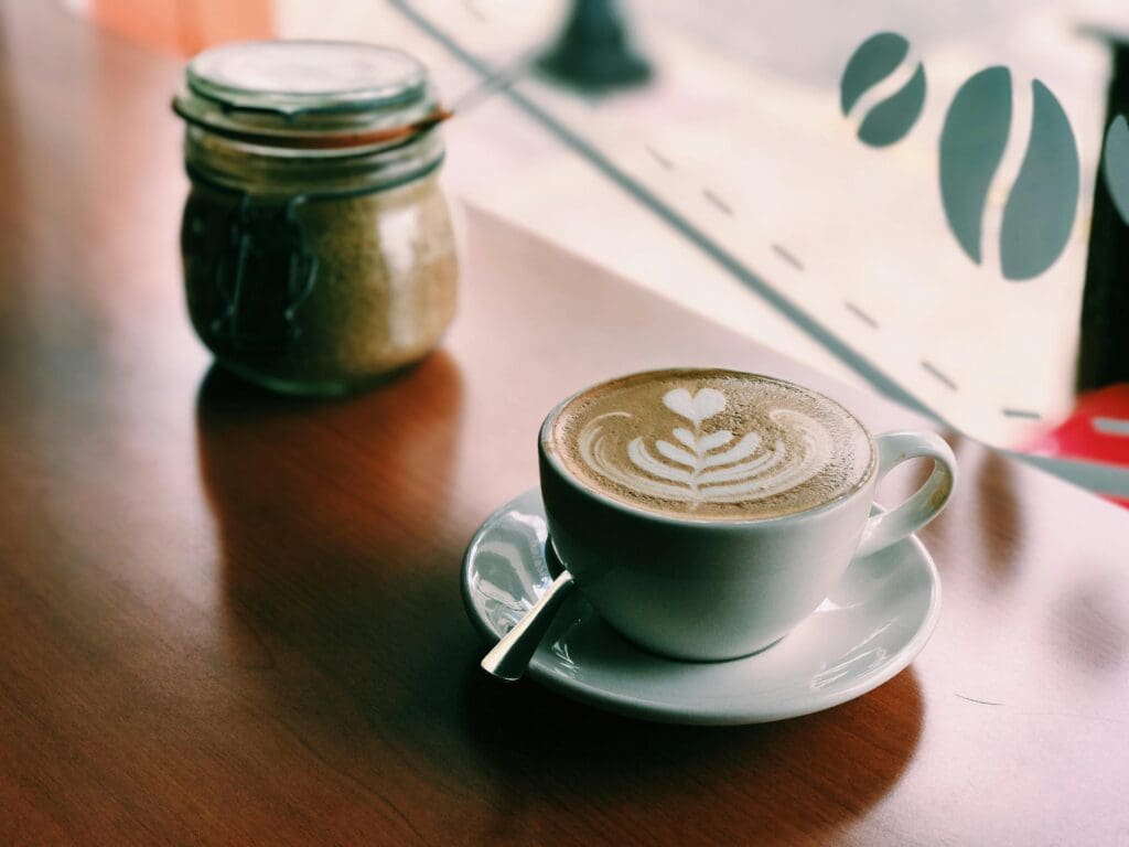 A picture of a latte in front of a window